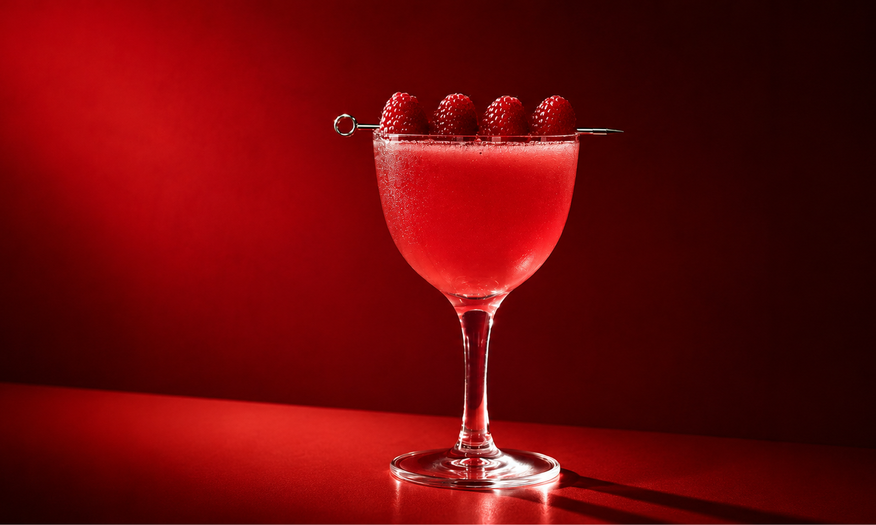 Red Veenus raspberry cocktail on red backdrop